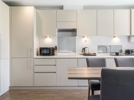 A kitchen with cabinets and appliances at Cotswolds Apartments 2B/S4 in Chipping Norton