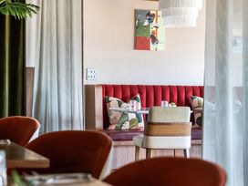 A dining area with a sofa and table at Cotswolds Apartments 2B/S4 Chipping Norton