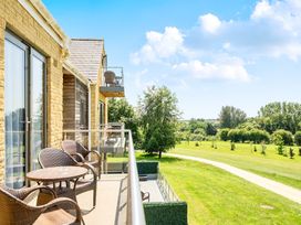 An outdoor balcony with chairs and table at Cotswolds Apartments 4B/S8 in Chipping Norton