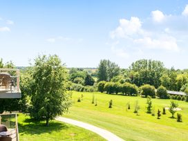 A view of a grassy area with trees and a pathway at Cotswolds Apartments 4B/S8 in Chipping Norton