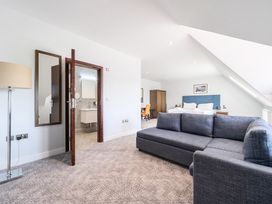 A living room with a sofa and a table at Cotswolds Apartments 4B/S8 in Chipping Norton