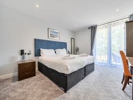 A bedroom with a bed and nightstand at Cotswolds Apartments 4B/S8 in Chipping Norton