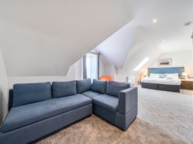 A bedroom with a sofa and bed at Cotswolds Apartments 4B/S8 in Chipping Norton