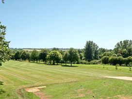 A grassy field with trees and a clear sky at Cotswolds Apartments 4B/S8 in Chipping Norton