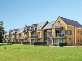 An apartment building with balconies and grass at Cotswolds Apartments 4B/S8 in Chipping Norton