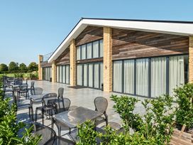 An outdoor terrace with tables and chairs at Cotswolds Apartments 4B/S8 in Chipping Norton