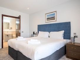 A bedroom with a double bed and attached bathroom at Cotswolds Apartments 4B/S8, Chipping Norton