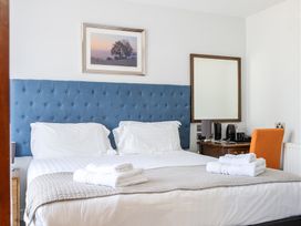 A bedroom with a bed and a desk at Cotswolds Apartments 4B/S8 Chipping Norton