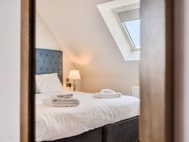 A bedroom with a bed and a bedside lamp at Cotswolds Apartments 4B/S8 in Chipping Norton