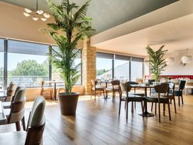 A dining room with tables and chairs at Cotswolds Apartments 4B/S8 in Chipping Norton