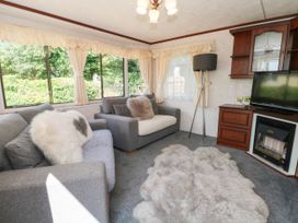 A living room with two sofas and a television at Buzzards Retreat in Wrexham