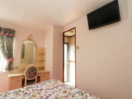A bedroom with a bed and vanity table at Buzzards Retreat in Wrexham