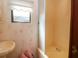 A bathroom with a sink and shower at Buzzards Retreat in Wrexham