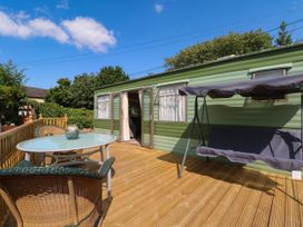An outdoor seating area with a table and chairs at Buzzards Retreat Wrexham