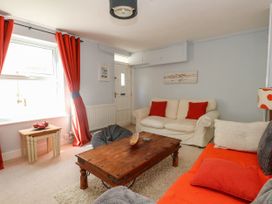 A living room with sofa and coffee table at Driftmark in Weymouth