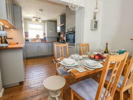 A kitchen with a dining table set for a meal at Driftmark in Weymouth