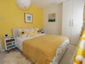 A bedroom with a bed and artwork at Driftmark in Weymouth