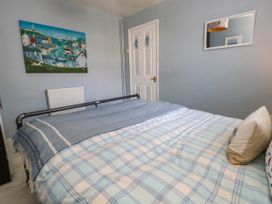 A bedroom with a bed and a painting at Driftmark in Weymouth