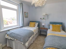 A bedroom with two beds and a window at Driftmark in Weymouth