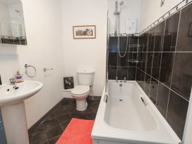 A bathroom with a bathtub and toilet at Driftmark in Weymouth