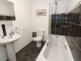 A bathroom with a sink, toilet, and bathtub at Driftmark in Weymouth