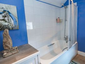 A bathroom with a bathtub and shower at Driftmark in Weymouth
