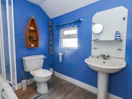 A bathroom with a toilet and sink at Driftmark in Weymouth