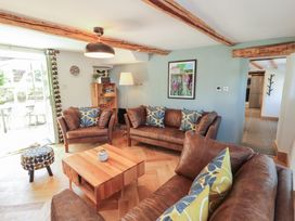 A living room with sofas and a coffee table at Haws Bank Cottage in Coniston