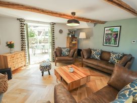 A living room with sofas and a coffee table at Haws Bank Cottage in Coniston
