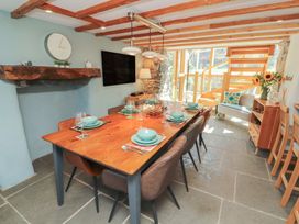 A dining room with a large table and chairs at Haws Bank Cottage in Coniston