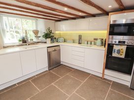 A kitchen with sink and appliances at Haws Bank Cottage in Coniston