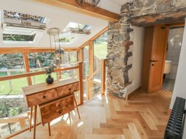 A hallway with a wooden dresser and skylights at Haws Bank Cottage in Coniston