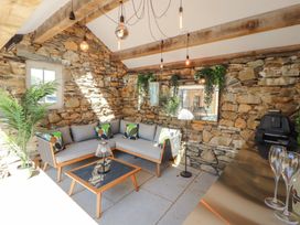 A snug with a sofa and coffee table at Haws Bank Cottage in Coniston