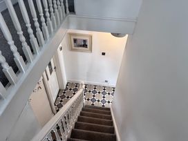 A staircase leading to a hallway at Conway Mart Cottage in Conwy