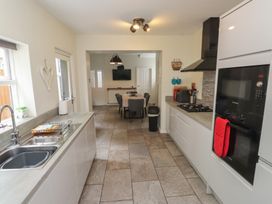 A kitchen with sink and countertop and dining area at Conway Mart Cottage in Conwy