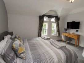 A bedroom with a bed and desk at Conway Mart Cottage in Conwy