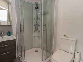 A bathroom with shower and toilet at Conway Mart Cottage in Conwy