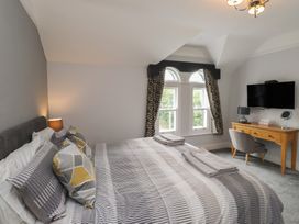 A bedroom with a bed and a desk at Conway Mart Cottage in Conwy