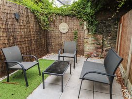 A garden featuring chairs and a table at Conway Mart Cottage in Conwy
