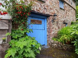 An exterior view of a blue door with wooden sign The Mill at The Water Mill at Boyton Mill Launceston