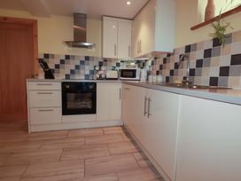 A kitchen with cabinets, oven, sink, and appliances at The Water Mill at Boyton Mill, Launceston