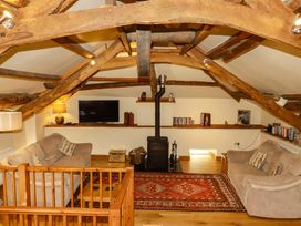 A living room with a sofa and television at The Water Mill at Boyton Mill in Launceston