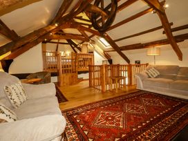 A living room with a sofa and wooden accents at The Water Mill at Boyton Mill Launceston