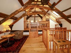 A loft with wooden beams and a sofa at The Water Mill at Boyton Mill Launceston