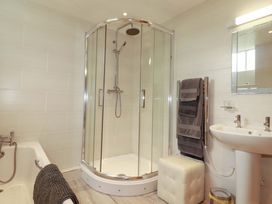 A bathroom with a shower, bathtub, and sink at The Water Mill at Boyton Mill in Launceston