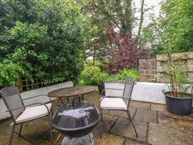 A garden area with a table and chairs at The Water Mill at Boyton Mill Launceston