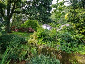 A garden with trees and plants at The Water Mill at Boyton Mill Launceston