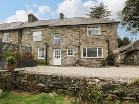 A stone building with windows and door at Ty Mawr Criccieth