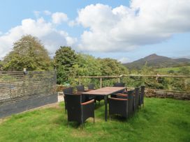 A table with chairs in a garden at Ty Mawr in Criccieth