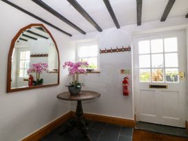A hallway with a mirror and a table at Ty Mawr in Criccieth